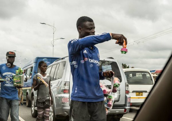 - Public Eye Magazin, page 7:"Les centaines de marchands ambulants, qui luttent pour survivre en vendant babioles ou autres boissons au milieu du trafic, sont directement exposés à des gaz d’échappement particulièrement nocifs". / "Mitten im Abgas: Strassenhändlerin und -händler in Accra, Ghana." - Dirty Diesel. How Swiss Traders Flood Africa with Toxic Fuels. A Public Eye Investigation, September 2016., page 72 : "Accra’s problem is less the number of cars that groove the streets than the bursts of thick black fumes the vehicles spit, subsequently inhaled by hordes of hawkers, drenched in sweat, scraping a living selling trinkets, cold drinks and SIM cards to the prisoners of the infernal traffic". Ghana, Accra.